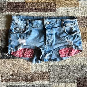 Zara low-rise light blue denim shorts with red pocket detail